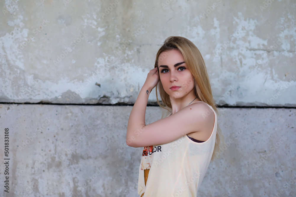 Portrait of Young Woman on Wall Background. Trendy Urban Fashion Concept. Outdoor closeup portrait of young sexy crazy girl Portrait of Young Woman on Wall Background. Trendy Urban Fashion Concept. Outdoor closeup portrait of young sexy crazy girl