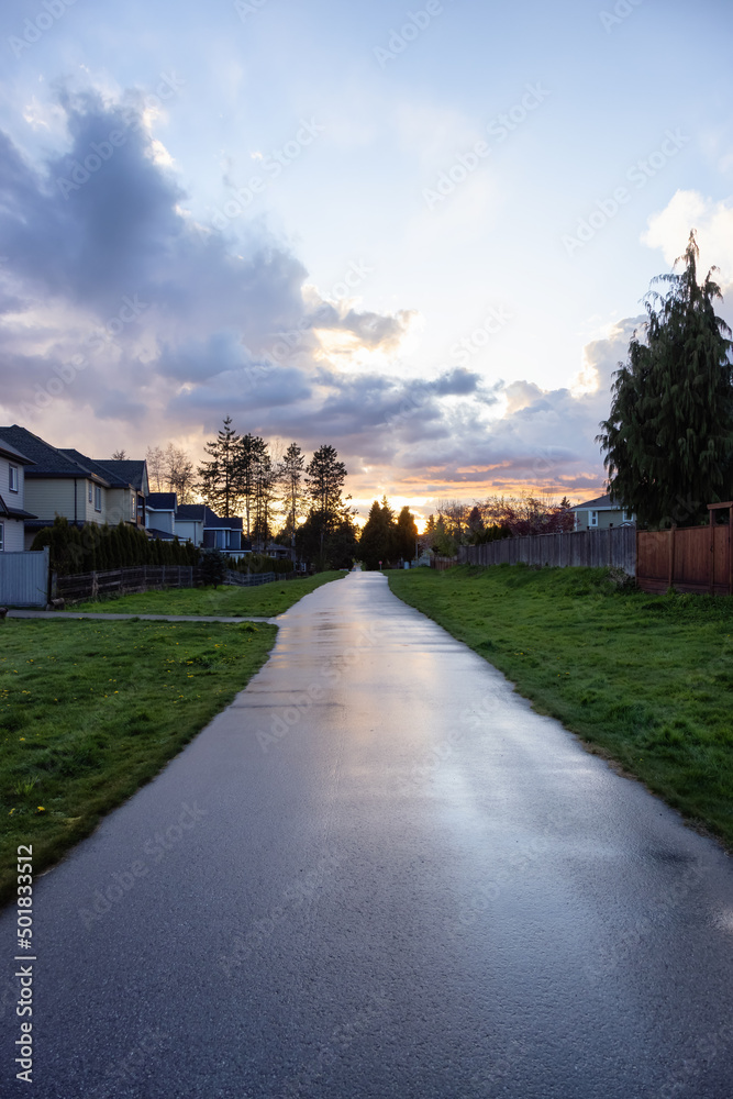 Fraser Heights, Surrey, Greater Vancouver, BC, Canada. Path in the Residential Neighborhood during a colorful spring season. Colorful Sunset Sky.
