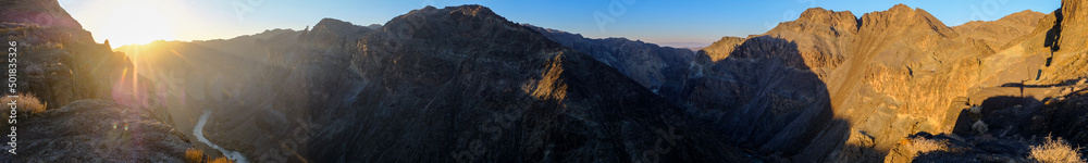 Fototapeta premium Colorful golden sunset on canyon background. Outdoor landscape. Scenic background. Nature background. Black canyon on Sharyn river in Kazakhstan.