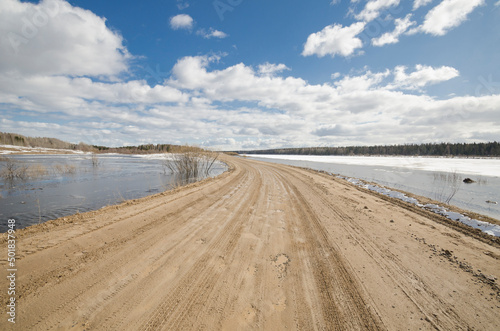 Fototapeta Naklejka Na Ścianę i Meble -  Flooding in the north. Flooded road. spring flood