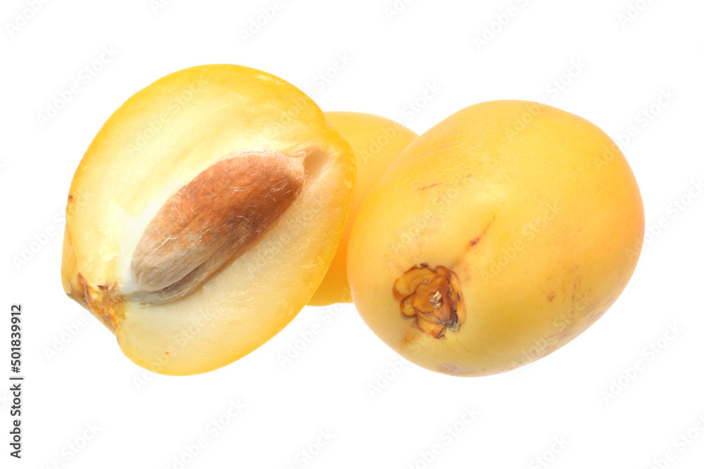 Ripe yellow date fruits half with stone and whole closed up isolated on white with clipping path Ripe yellow date fruits half with stone and whole closed up isolated on white with clipping path