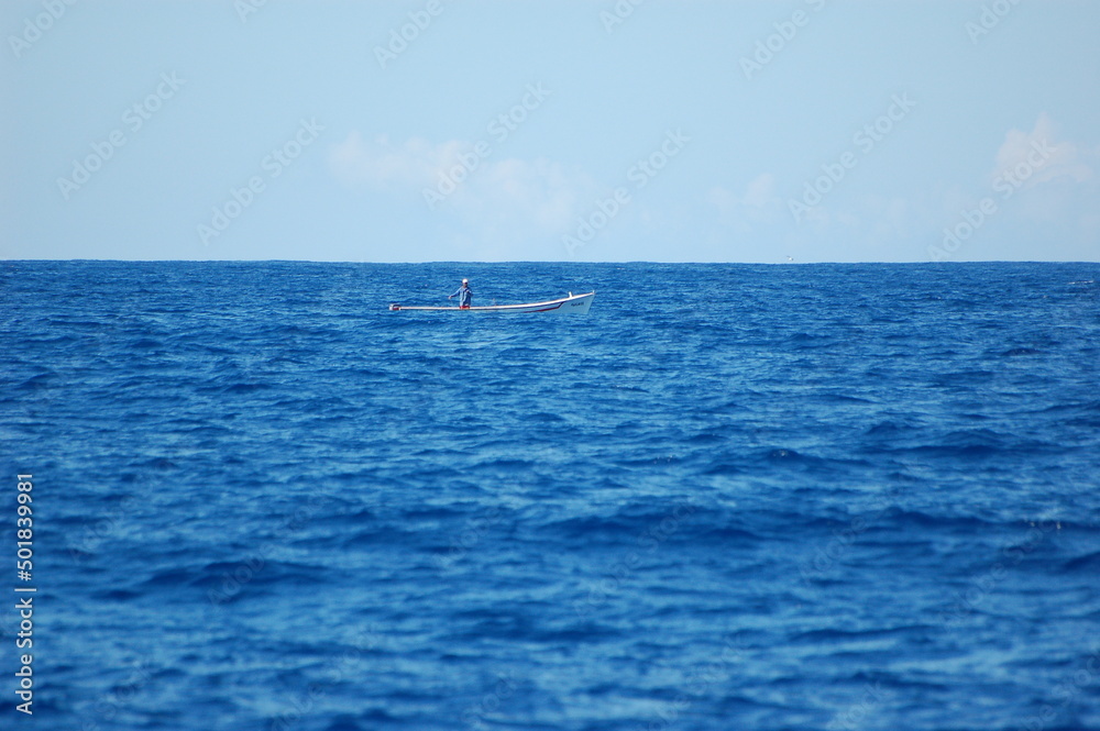 fisherman boat in the blue sea off the coast of mauritius