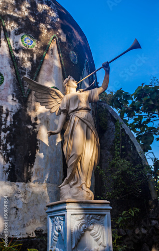 An angel statue in front of Gereja Ayam (Chicken Church), a famous church in Magaleng because of its unique design and its location that near Borobudur temple.  photo