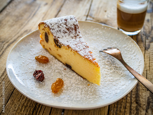 Cheesecake with raisins on wooden table