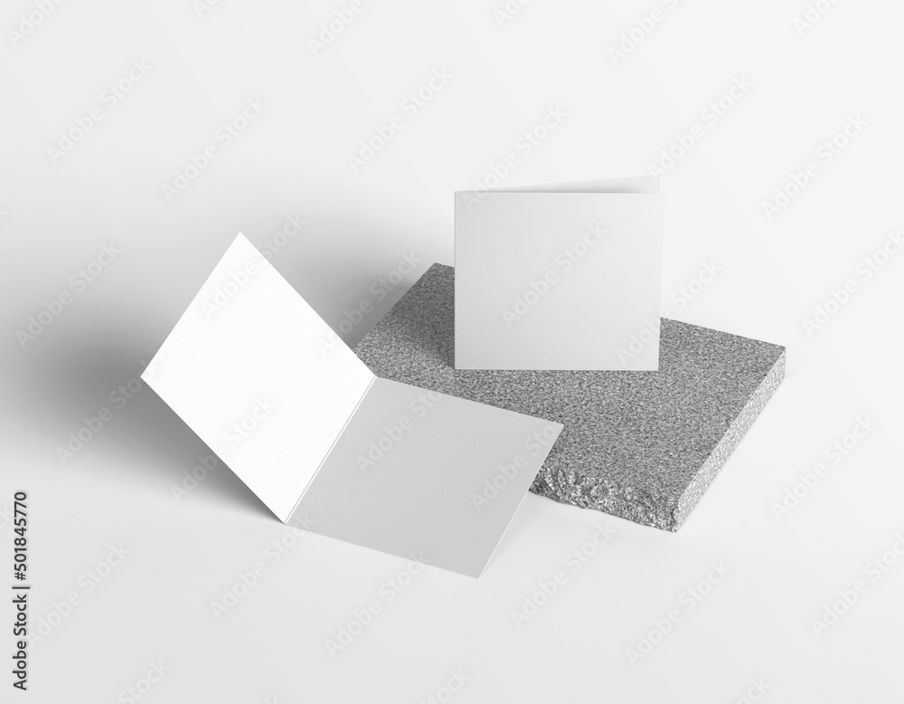 Two plain empty plain white close and open square paper brochure on marble block Two plain empty plain white close and open square paper brochure on marble block