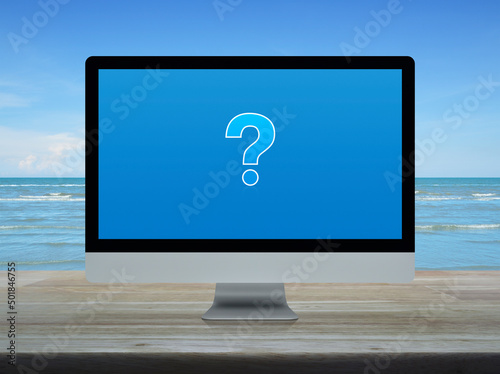 Question mark sign icon on modern laptop computer screen on wooden table over tropical sea and blue sky with white clouds, Business customer service and support online concept