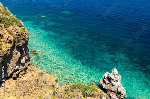 Aerial view of the crystal clear sea water at Spiaggia dello Scario beach in Malfa, Salina, Aeolian Islands. People enjoy the sun and sand on a clear summer day. Beautiful holiday destination.
 photo