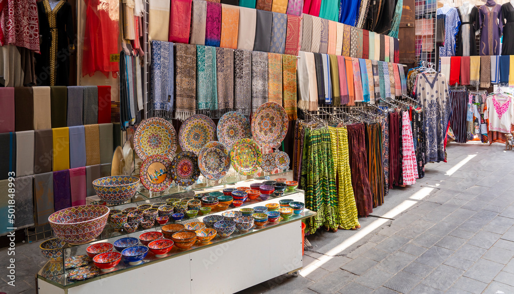 Dubai, UAE. View of the old Bur Dubai textile souk market in Creek Colorful stores with textiles goods, souvenirs and accessories. Touristic destination Stock-foto | Adobe Stock