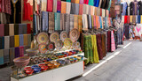 Dubai, UAE. View of the old Bur Dubai textile souk market in Creek district. Colorful stores with textiles goods, souvenirs and accessories. Touristic destination