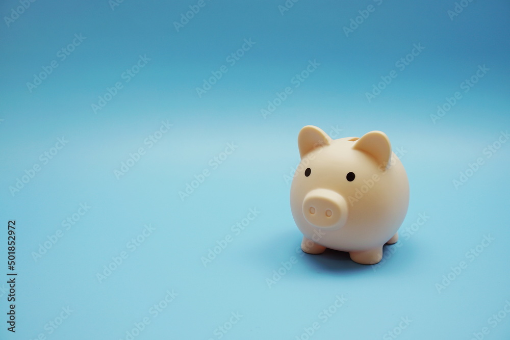 Piggy bank with space copy on blue background