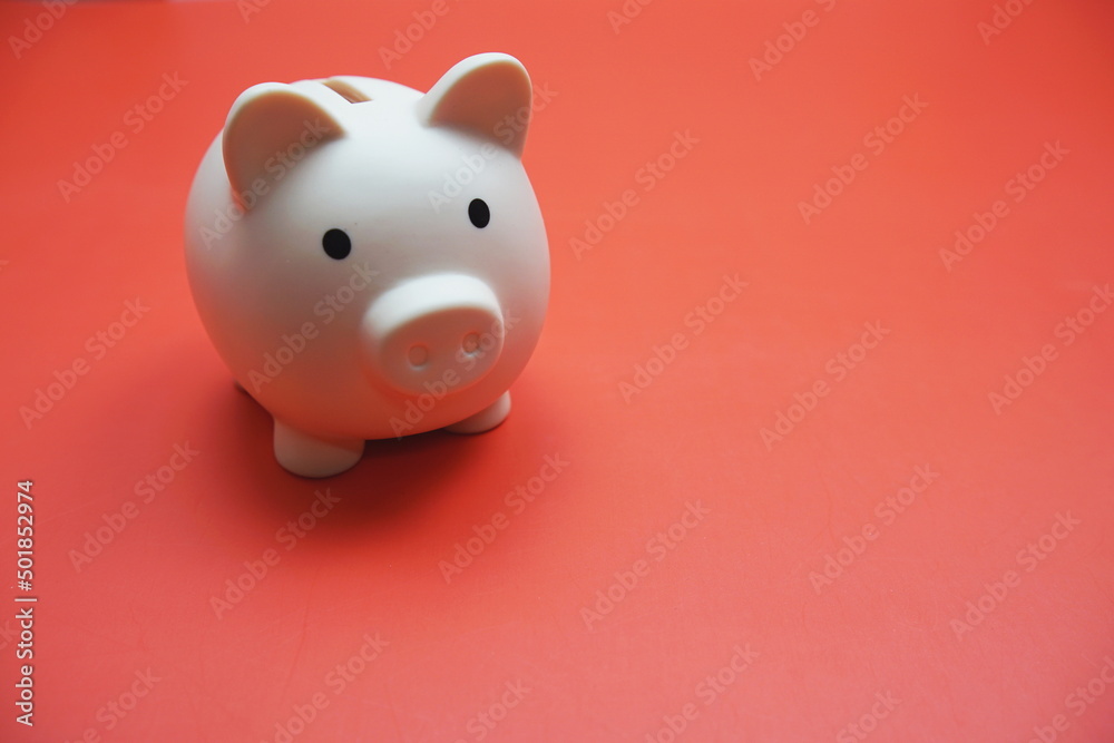 Piggy bank with space copy on red background