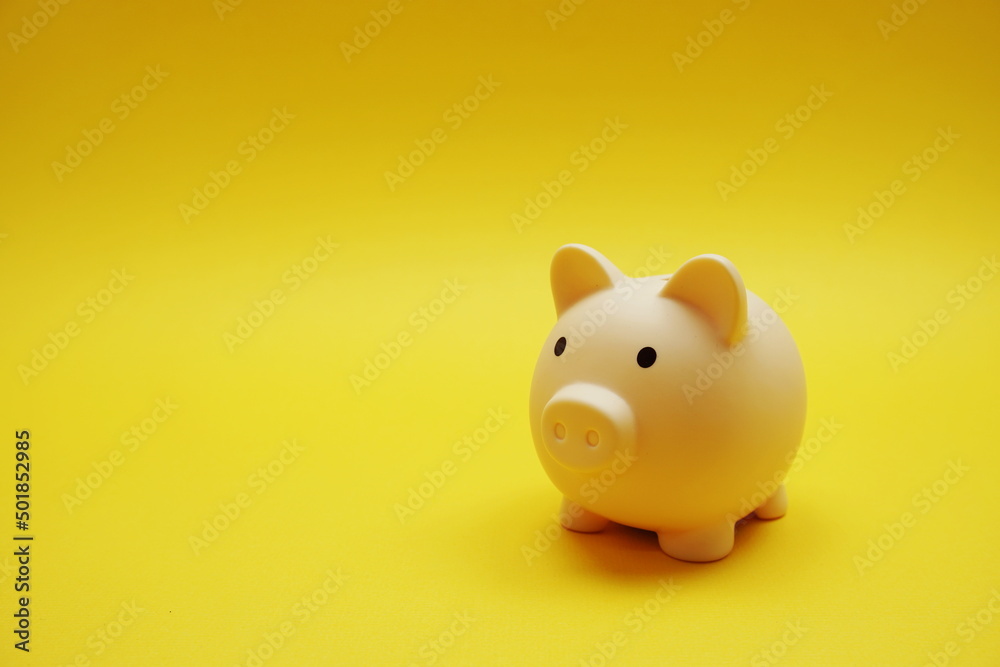 Piggy banks saving with space copy on yellow background