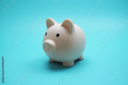 Piggy Bank Saving finance concept on blue background