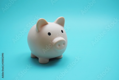 Piggy Bank Saving finance concept on blue background