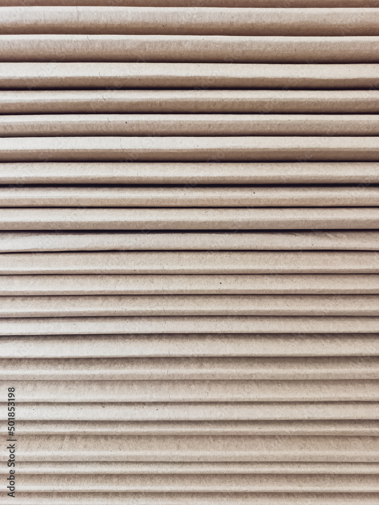 Side view of a corrugated cardboard. Cardboard boxes are folded on a pallet. Corrugated cardboard sheets are one by one.