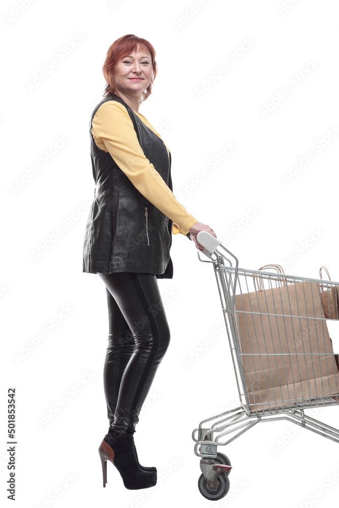 happy mature woman with shopping cart. isolated on a white
