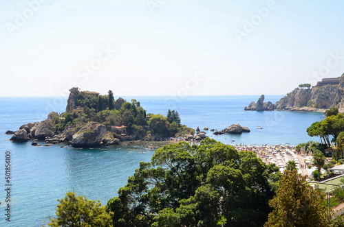 Isola Bella, small island near Taormina, Sicily, Italy. A small sand strip connects it to Taormina beach, surrounded by crystal clear turquoise azure waters of the Ionian Sea.