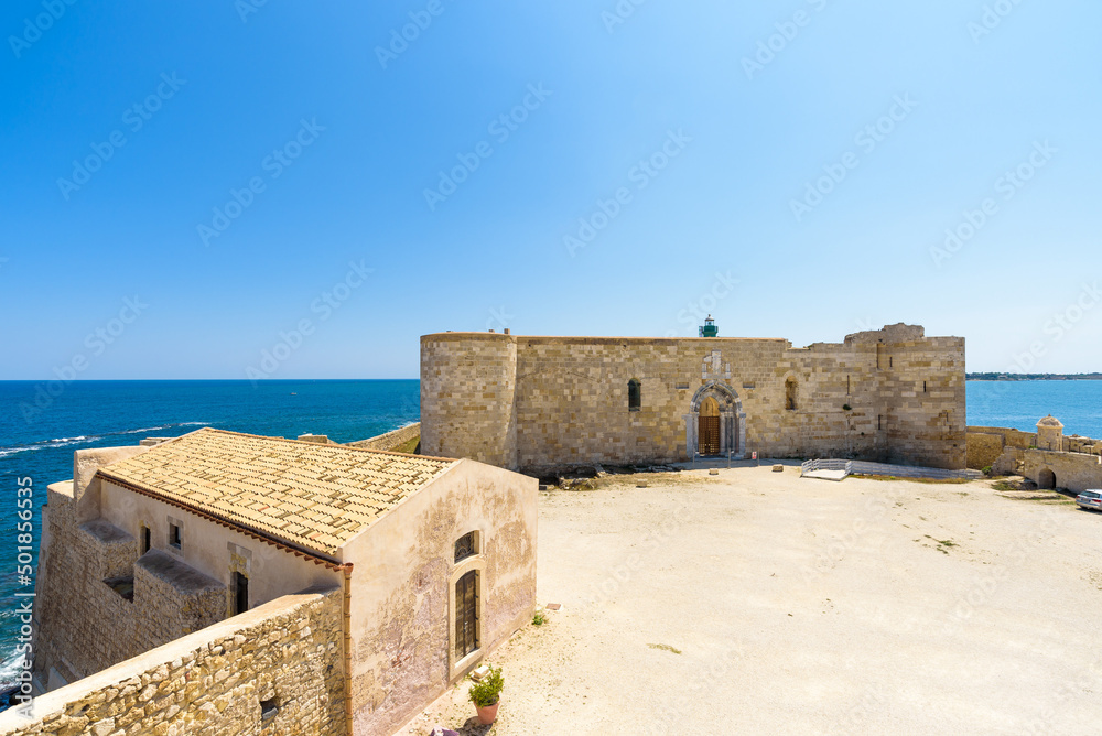 The Maniace Castle in the island of Ortigia. It was built during the Swabian period by Emperor Frederick II of Swabia. It features a decorated portal, arches, towers, a banquet room and a lighthouse.