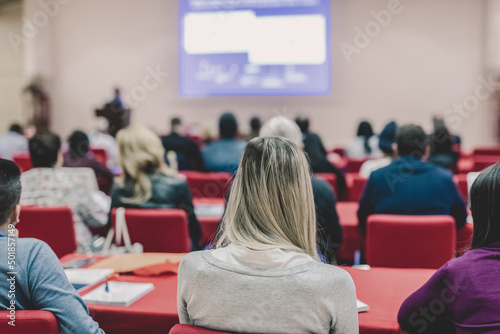 Audience in lecture hall on scientific conference.