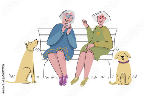 Two older women spend time together. Elderly friends sitting on a bench in park. Pet owners walking with dogs.