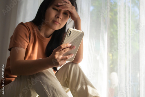 Stressed woman talking on the phone. Shocked woman receiving bad news at phone. Depressed woman must stay in home quarantine due to covid-19. sad depression female. unhappy, failure, sadness concepts