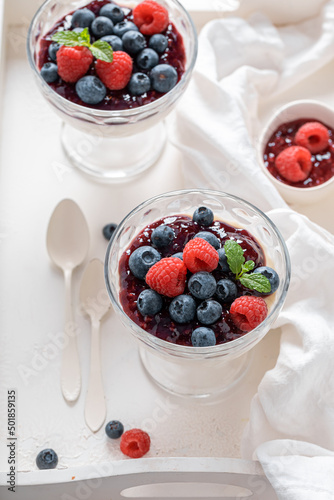 Homemade and sweet Panna Cotta with berries mousse.