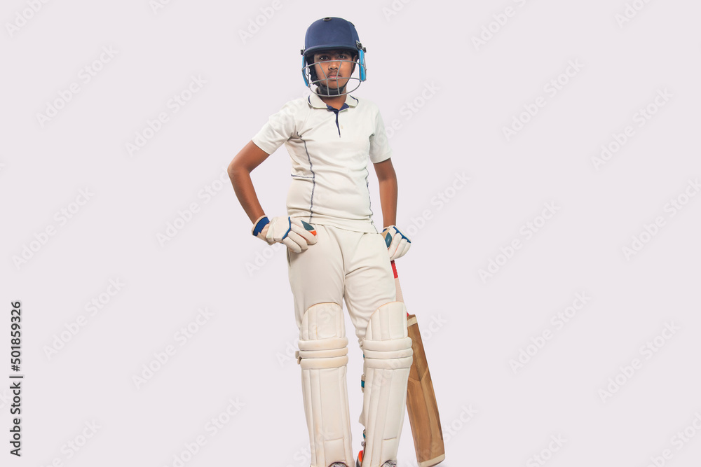 full length of a boy in cricket uniform standing with bat full length of a boy in cricket uniform standing with bat
