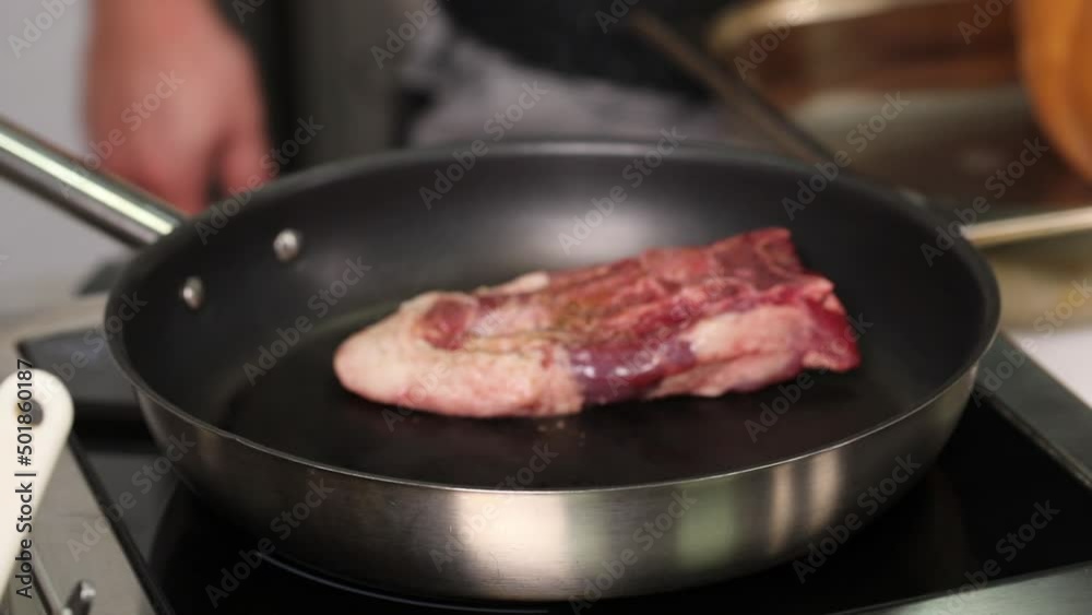 Chef frying meat in a pan
Chef frying meat in a pan
