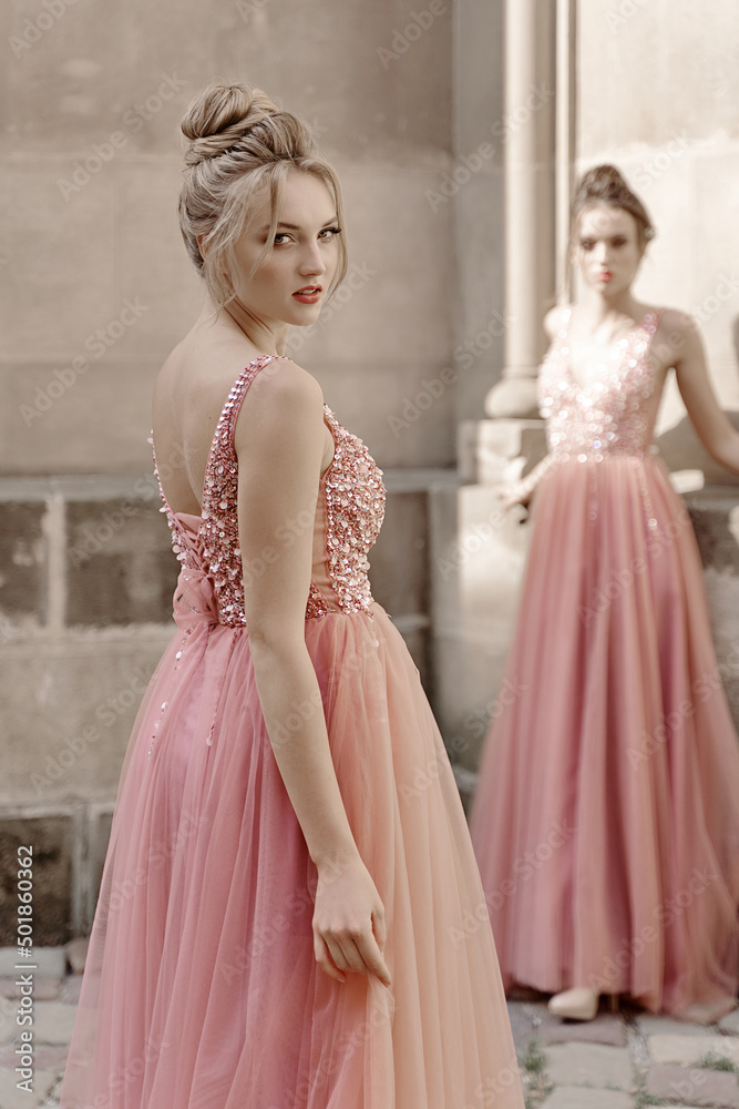 European girls bridesmaids in pink dresses having fun