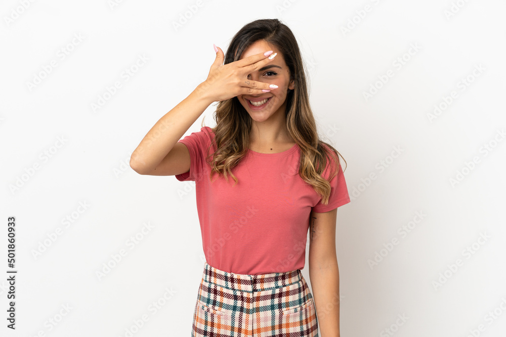Young woman over isolated background covering eyes by hands and smiling Young woman over isolated background covering eyes by hands and smiling