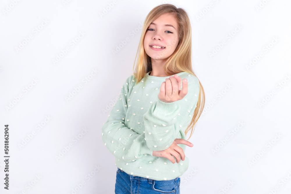 little caucasian kid girl wearing fashion sweater over blue background Beckoning come here gesture with hand inviting welcoming happy and smiling little caucasian kid girl wearing fashion sweater over blue background Beckoning come here gesture with hand inviting welcoming happy and smiling
