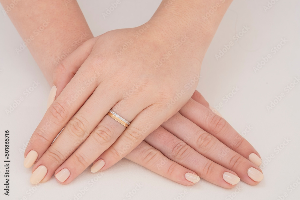 Golden Ring on a female hand, diamonds Diamond ring in hands of young lady. Close-up photo shoot Golden Ring on a female hand, diamonds Diamond ring in hands of young lady. Close-up photo shoot