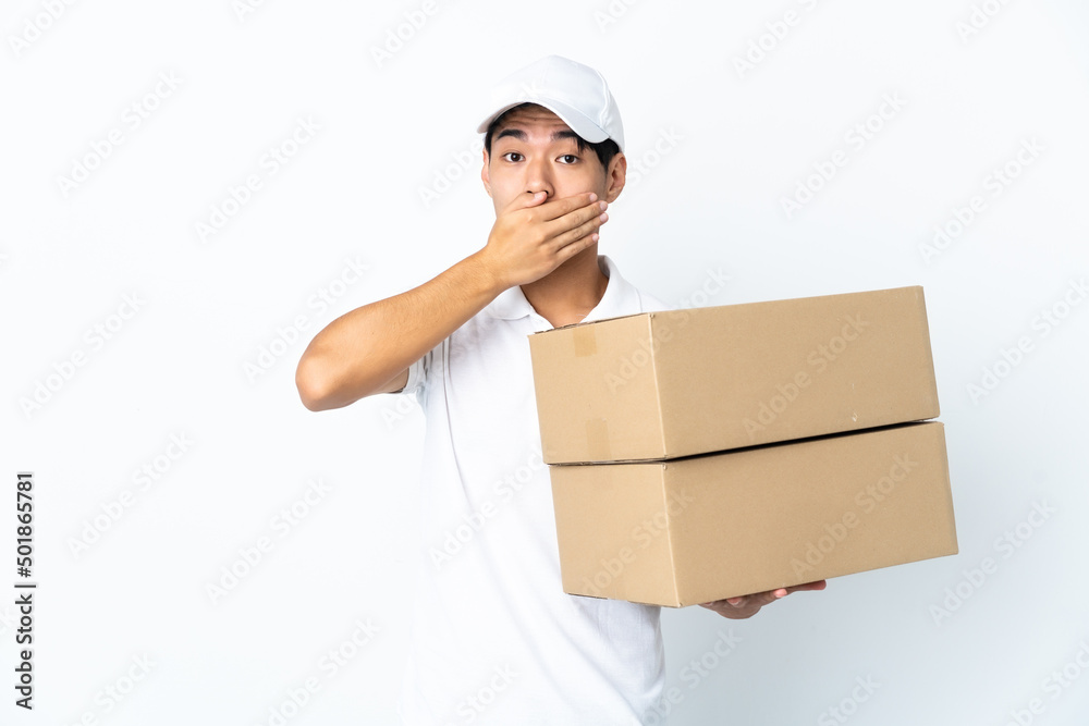 Delivery Chinese man isolated on white background covering mouth with hand Delivery Chinese man isolated on white background covering mouth with hand