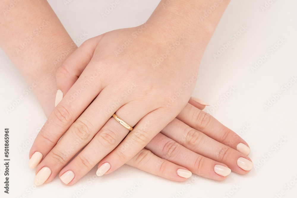 Golden Ring on a female hand, diamonds Diamond ring in hands of young lady. Close-up photo shoot Golden Ring on a female hand, diamonds Diamond ring in hands of young lady. Close-up photo shoot