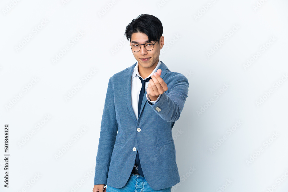 Young Chinese business man isolated on white background making money gesture Young Chinese business man isolated on white background making money gesture
