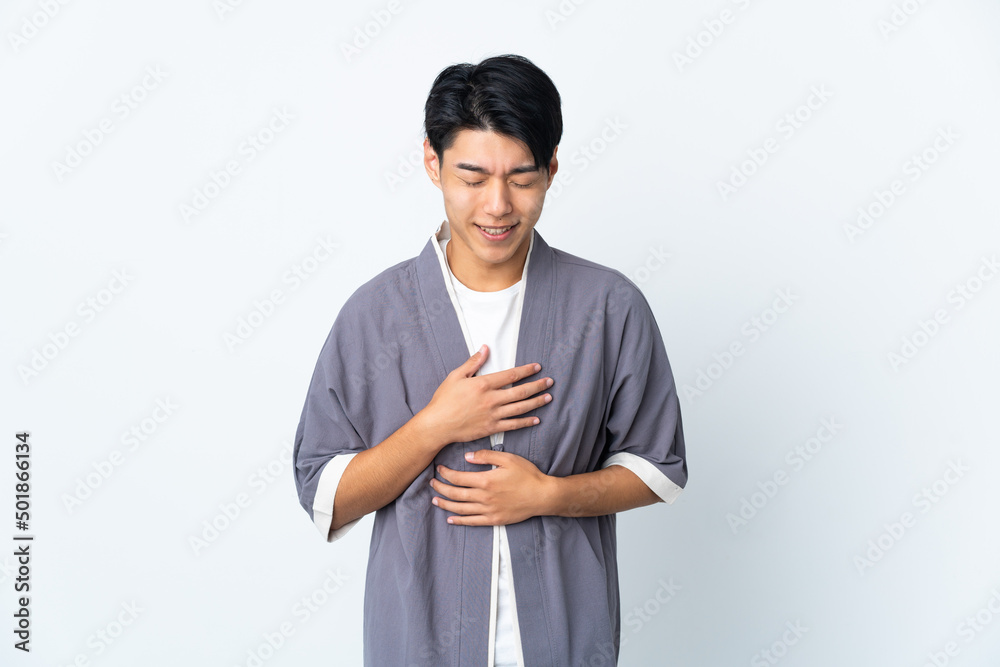 Young Chinese man isolated on white background smiling a lot