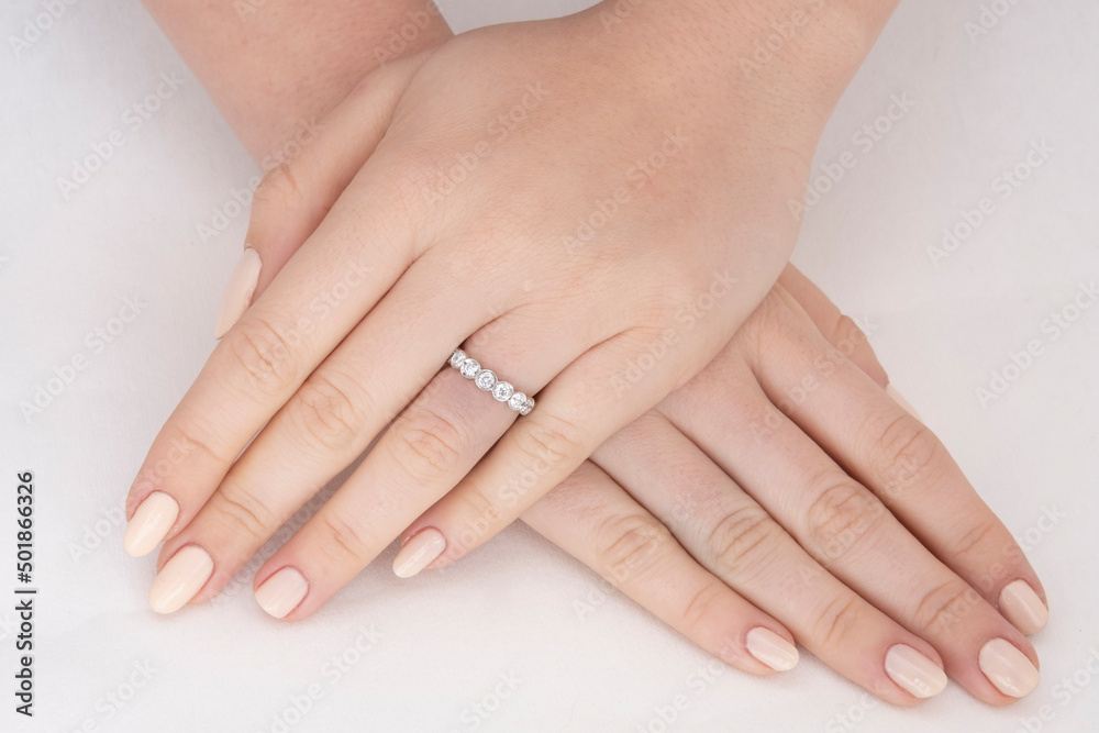 Golden Ring on a female hand, diamonds Diamond ring in hands of young lady. Close-up photo shoot