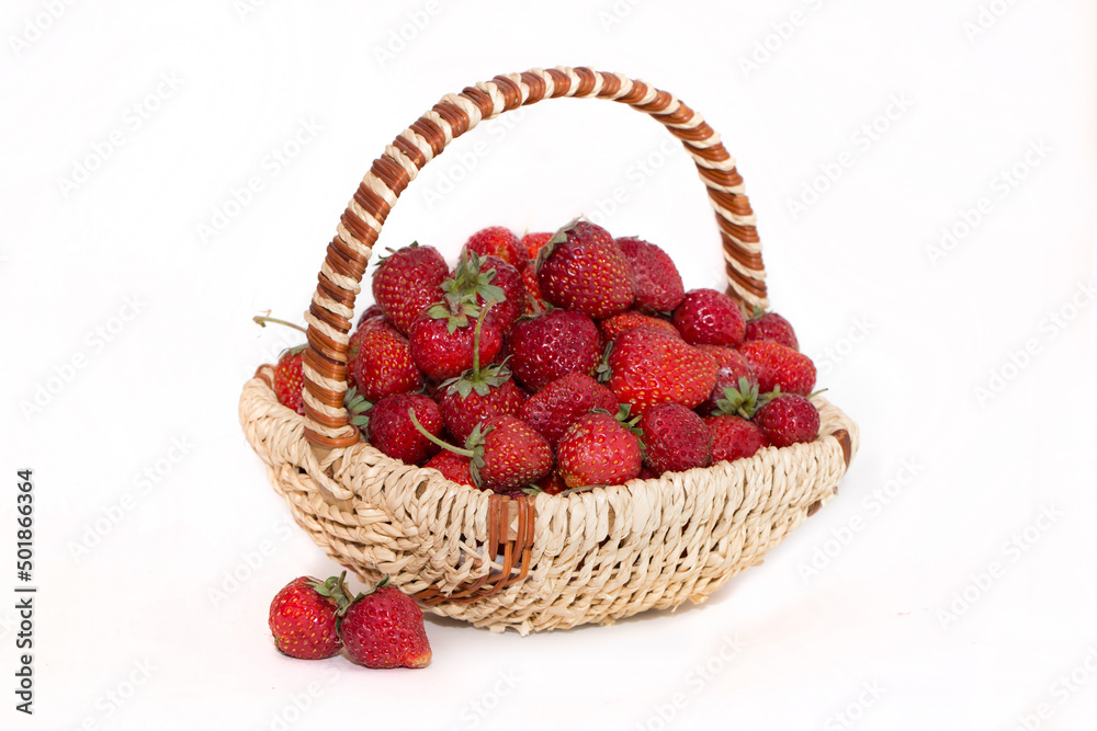 Basket with strawberries on a white background. Strawberry close-up isolated. Juicy berries picked for dessert. Basket with strawberries on a white background. Strawberry close-up isolated. Juicy berries picked for dessert.