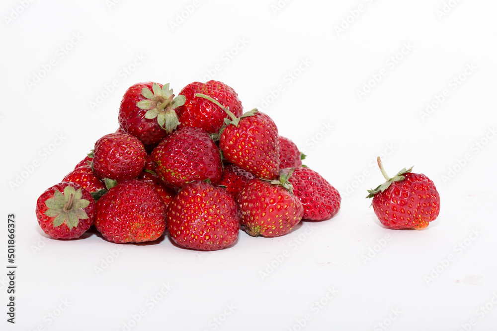 Strawberries on a white background. Strawberry close-up isolated. Juicy berries picked for dessert. Strawberries on a white background. Strawberry close-up isolated. Juicy berries picked for dessert.