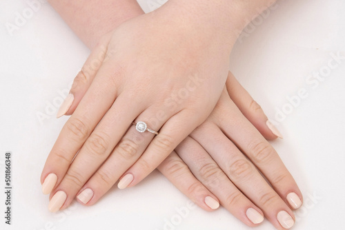 Golden Ring on a female hand, diamonds Diamond ring in hands of young lady. Close-up photo shoot