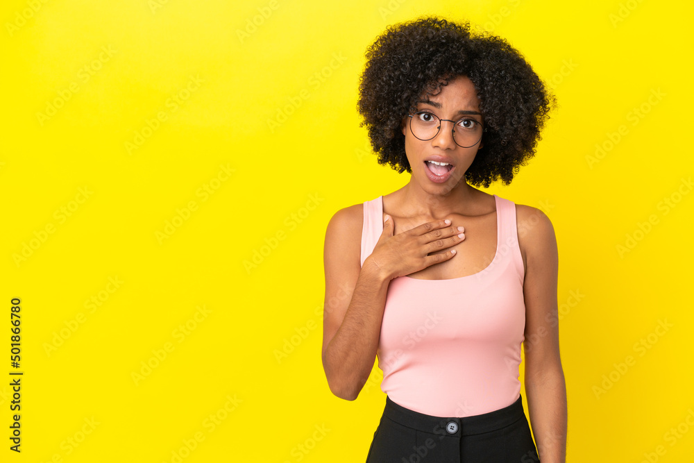 Young African American woman isolated on yellow background pointing to oneself Young African American woman isolated on yellow background pointing to oneself