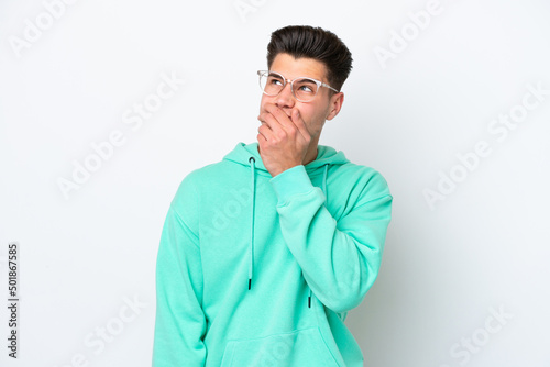 Young handsome caucasian man isolated on white bakcground having doubts and with confuse face expression