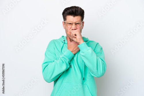 Young handsome caucasian man isolated on white bakcground coughing a lot © luismolinero