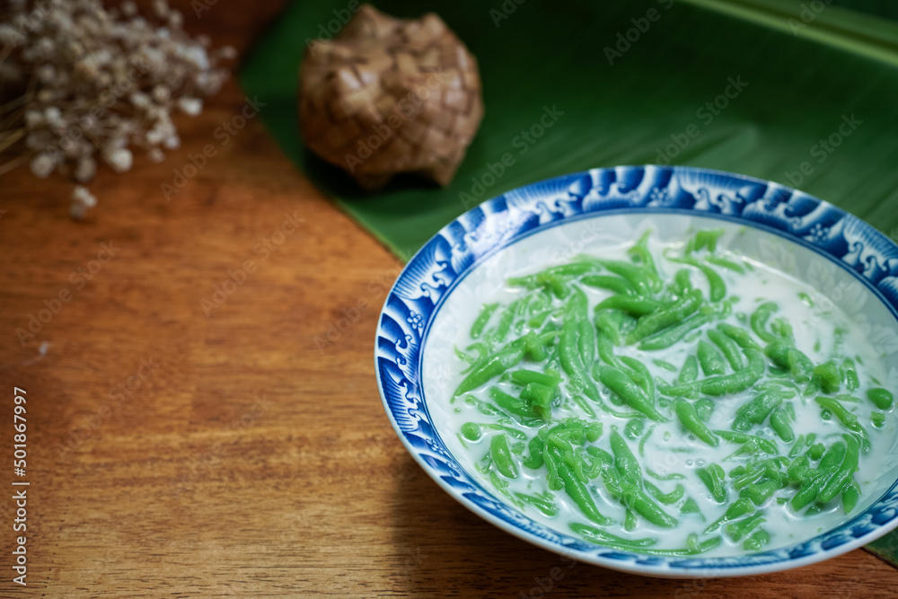 Lod Chong, Thai dessert, Lod Chong with coconut milk on a wooden floor. Lod Chong, Thai dessert, Lod Chong with coconut milk on a wooden floor.