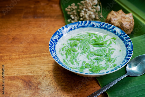 Lod Chong, Thai dessert, Lod Chong with coconut milk on a wooden floor. photo