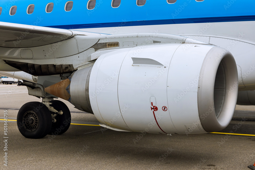 Close up of an engine of big passenger airplane on airport Close up of an engine of big passenger airplane on airport