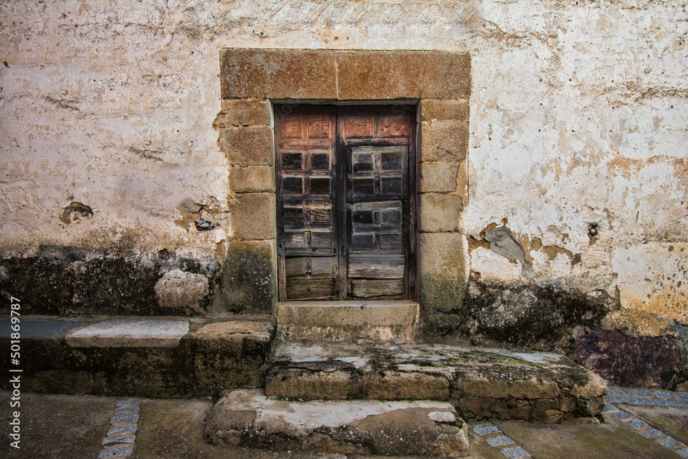 Facade Of An Abandoned House With An Old Patched Wooden Door. Abandoned Houses. Image With Texture And Copy Space. Evicted Housing Concept Facade Of An Abandoned House With An Old Patched Wooden Door. Abandoned Houses. Image With Texture And Copy Space. Evicted Housing Concept