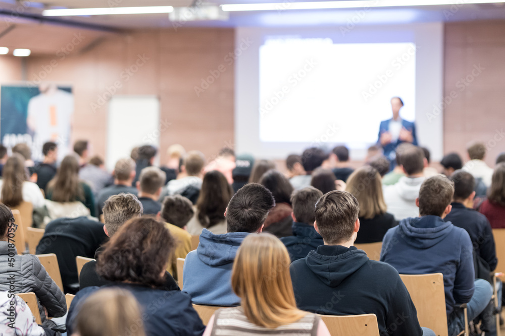 Business speaker giving a talk at business conference event.