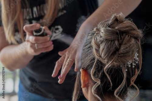Stylist combing a bride