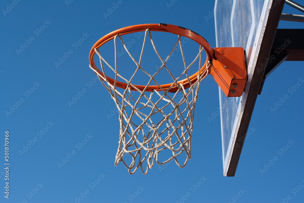 Old basketball goal against the blue sky, side view, close-up